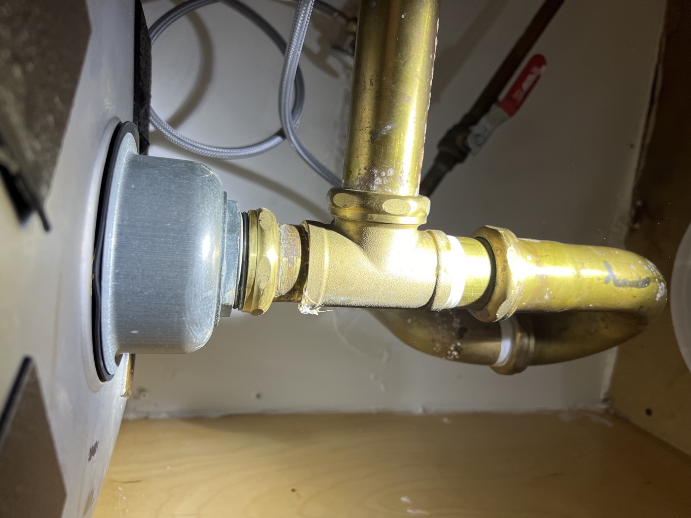 Drain and P-trap plumbing repair under a kitchen sink