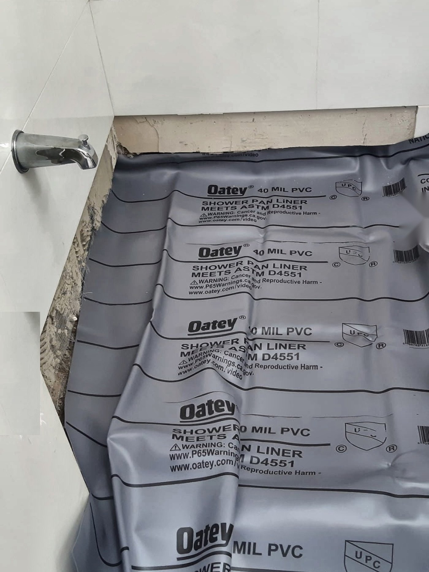 Oatey PVC shower pan liner installed before tile in a bathroom renovation